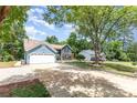 Long driveway leading to a two-story home with mature trees and landscaping at 7218 Jacobs Fork Ln, Charlotte, NC 28273