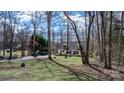 Two-story home with a long driveway and expansive lawn, offering privacy and space surrounded by trees at 7648 Forest Oak Dr, Denver, NC 28037