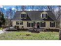 Charming two-story home with a welcoming front porch and a cozy deck, surrounded by lush greenery at 7648 Forest Oak Dr, Denver, NC 28037