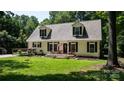 Charming two-story home with dormer windows, black shutters, inviting front porch, and well-maintained front lawn at 7648 Forest Oak Dr, Denver, NC 28037