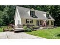 Attractive home featuring a welcoming porch, a wooden deck, dormer windows and an inviting driveway at 7648 Forest Oak Dr, Denver, NC 28037
