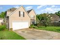 Attractive home with a two-car garage, a well-kept lawn, and established greenery at 8414 Oak Ne Dr, Charlotte, NC 28269