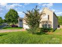 Inviting two-story home with a lush green lawn and mature landscaping for added curb appeal at 8414 Oak Ne Dr, Charlotte, NC 28269