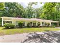 A home's long side with several horizontal windows, nicely landscaped, and a tree-lined property at 981 Sherwood Cir, Lancaster, SC 29720