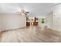 An open-concept living room boasts new wood flooring, neutral walls, and abundant natural light at 1055 Cedar Hill Dr, Rockwell, NC 28138
