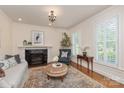 Comfortable living room with fireplace, plush seating, and natural light at 12048 Royal Portrush Dr, Charlotte, NC 28277