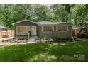 Charming home featuring a lush front yard, fresh landscaping, and a welcoming entrance at 1208 Tarrington Ave, Charlotte, NC 28205