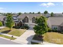 An aerial view showing a well-manicured lawn, mature trees, and a neighborhood setting at 13315 Hunting Birds Ln, Charlotte, NC 28278