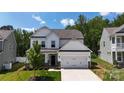 Beautiful two-story home boasts lush landscaping, a spacious two-car garage, and inviting curb appeal at 154 Cotton Field Dr, Statesville, NC 28677