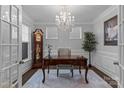 A charming home office featuring a chandelier, classic desk, and hardwood floors, ideal for remote work at 154 Cotton Field Dr, Statesville, NC 28677
