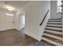 Bright foyer with hardwood flooring, staircase, and doorway with glass French doors at 1540 Striped Bass Ln, Clover, SC 29710