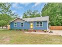 Charming single-story home with a well-manicured lawn and inviting yellow door at 1724 Virginia St, Monroe, NC 28110