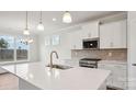 Modern kitchen with white cabinets, stainless steel appliances, quartz countertops, and a center island at 2031 Skyhawk Dr, York, SC 29745