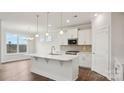 Bright open-concept kitchen featuring an island, stainless steel appliances, and pendant lighting at 2031 Skyhawk Dr, York, SC 29745