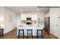 Modern kitchen with a large island, stainless steel appliances, and white cabinets at 222 Giant Oak Ave, Statesville, NC 28677