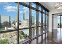 Sun-filled living area featuring floor to ceiling windows with captivating city views at 222 S Caldwell St # 1909, Charlotte, NC 28202