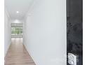 Bright white hallway with wood floors leading to a room with many windows at 231 Miramar Dr, York, SC 29745