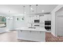 Modern kitchen features white cabinetry, stainless steel appliances, and a large island at 231 Miramar Dr, York, SC 29745
