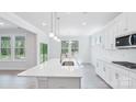 Bright, modern kitchen with white cabinets, a large island, and stainless steel appliances at 231 Miramar Dr, York, SC 29745