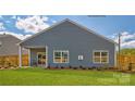 Spacious backyard features a covered patio, lush green lawn, and wood privacy fence at 249 Giant Oak Ave, Statesville, NC 28677