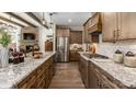 Modern kitchen with stainless steel appliances, wooden cabinets, granite countertops, and hardwood floors at 3099 Trace Meadow Ct, York, SC 29745