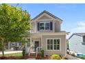 Charming two-story home with light gray siding, black shutters, and a welcoming front porch at 414 King St, Waxhaw, NC 28173