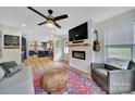 Open living room with fireplace, adjacent to the kitchen and filled with natural light at 456 Rainbow Cir, Clover, SC 29710