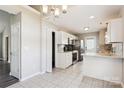 Bright kitchen with white cabinets, stainless steel appliances, granite countertops, and tile flooring at 5018 Drake Pond Ln, Rock Hill, SC 29732