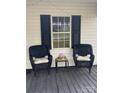 Cozy front porch seating area with wicker chairs, a table, and string lights for a relaxing outdoor space at 642 Boger St, Mooresville, NC 28115
