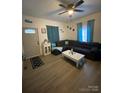 Cozy living room with a ceiling fan, modern furniture and decor, and natural light at 642 Boger St, Mooresville, NC 28115