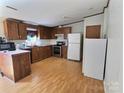 Functional kitchen with stainless steel appliances, wood cabinets, and ample countertop space for cooking at 668 Osteen Rd, York, SC 29745