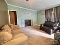 Cozy living room with fireplace, neutral carpet, and comfortable seating, perfect for relaxing and entertaining at 668 Osteen Rd, York, SC 29745