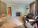 Inviting living room with a brick fireplace, neutral-toned walls, and a comfortable seating area at 668 Osteen Rd, York, SC 29745