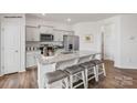 Modern kitchen features stainless steel appliances, granite countertops, and center island with seating at 739 Wagon Cross Ct, York, SC 29745