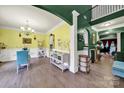 Bright dining room with chandelier, decorative wainscoting, and a unique color scheme creating a cheerful atmosphere at 7710 Grove Hall Ave, Mint Hill, NC 28227