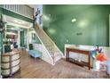 Welcoming two-story foyer with hardwood floors, staircase, and plenty of natural light at 7710 Grove Hall Ave, Mint Hill, NC 28227