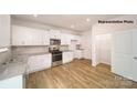Bright kitchen with white cabinets, stainless steel appliances, and a convenient pantry at 917 Two Brothers Ln, York, SC 29745