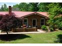 Inviting brick home with a red roof, a cozy front patio, and well-maintained landscaping at , Hickory, NC 28602