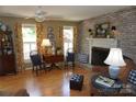 Comfortable living room with brick fireplace, hardwood flooring, and natural light at , Hickory, NC 28602
