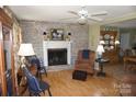 Cozy living room featuring a brick fireplace, hardwood floors, and traditional décor at , Hickory, NC 28602