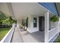 Inviting front porch with rocking chairs, hanging plants and painted gray flooring at 1001 Old Charlotte Rd, Concord, NC 28027