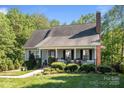 Traditional single-story home with a welcoming front porch, a well-kept lawn, and mature trees at 1002 4Th Ne St, Conover, NC 28613