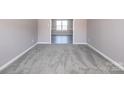 Neutral bedroom featuring soft carpet, base trim, and ample space at 10146 Hawkeye Dr # 2, Charlotte, NC 28273