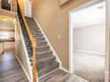Inviting entryway with staircase, wood floors, and doorway leading to a carpeted room at 10146 Hawkeye Dr # 2, Charlotte, NC 28273