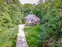 An aerial perspective shows a brick home on a large lot with a long driveway at 112 Eagle Chase Ln, Troutman, NC 28166