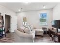 Comfortable living room featuring a large sofa, a window, and a doorway leading to another room at 1206 Keydet Dr, Charlotte, NC 28216