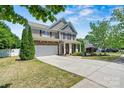 Beautiful two-story home with a spacious driveway, attached garage, and well-maintained lawn and landscaping at 142 Wellshire St, Mooresville, NC 28115