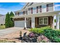 Inviting front entrance with a brick pathway, well-maintained landscaping, and a charming porch at 142 Wellshire St, Mooresville, NC 28115
