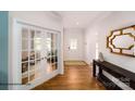 Welcoming foyer with hardwood floors, coat closet, and French doors leading to an office at 143 Apple Orchard Ct, Statesville, NC 28677
