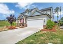 Beautiful house with a manicured lawn and a two-car garage on a sunny day at 1497 Striped Bass Ln, Clover, SC 29710